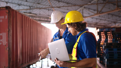 Warehouse workers are reviewing the list of items based on the documentation