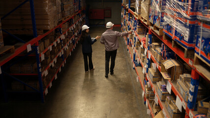 Business woman and warehouse workers are reviewing the list of items based on the documentation