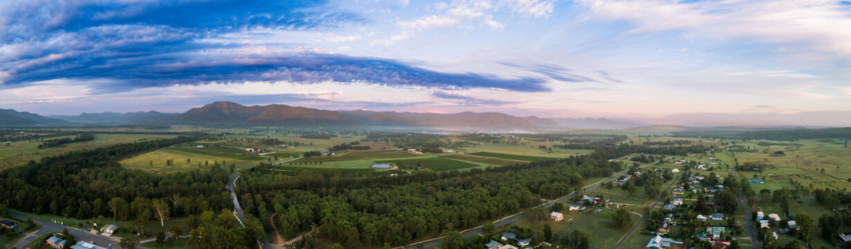 Wollombi Brook winding through green landscape in Broke NSW at first light of day