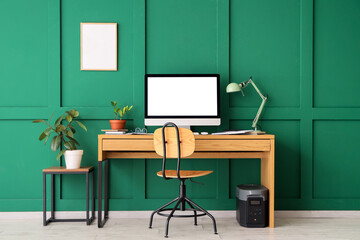 Interior of office with workplace, plants and blank frame