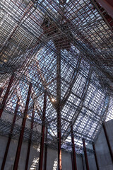 Uprisen angle photo shot of the huge steel roof frame structure detail under construction at the work site.