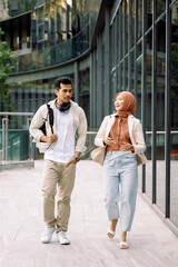 Fototapeta premium University students walking and talking on campus