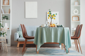 Interior of dining room with table setting and beautiful lemon tree branches