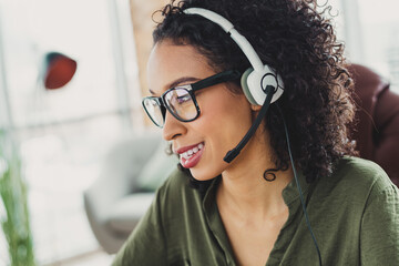 Confident Young Businesswoman Using a Headset in a Modern Office Environment for Professional...