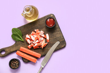 Wooden board with tasty crab sticks, spinach leaves and bowl of sauce on lilac background © Pixel-Shot