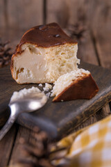 San Sebastian cheesecake on a wooden board on a wooden table