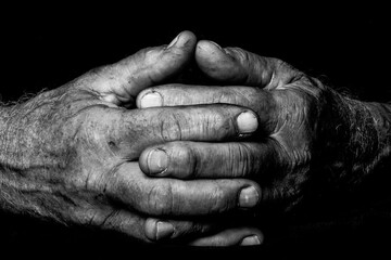 Rugged and rough hands of a lifelong manual worker in black and white