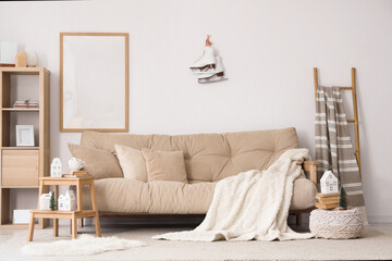 Light interior of living room with grey sofa and winter decor