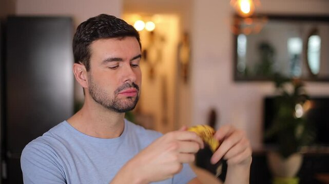 Handsome man eating a banana 