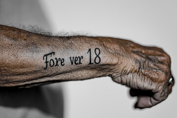 Forever Young Tattoo on Elderly Arm 
