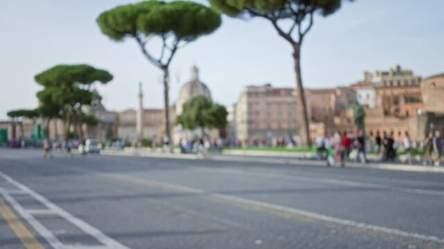 Blurred people exploring the historic ruins of the roman forum in rome with iconic trees and architecture, creating a dreamy and out-of-focus impression of the ancient city.