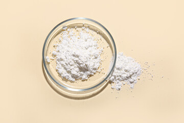 Petri dish with powder sample on yellow background