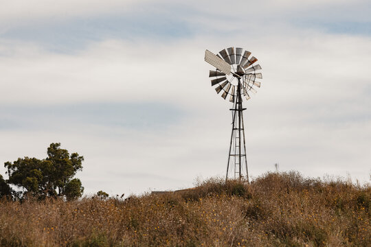 Rural Australian country scene with windmill on hill top