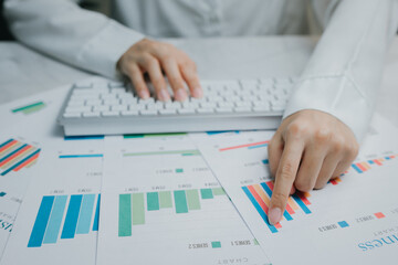 Hands analyzing data charts on a desk surface, Business concept