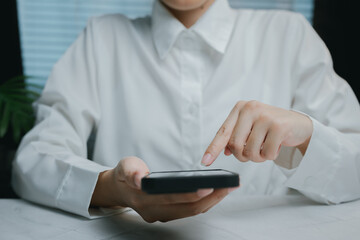 Person using smartphone in modern workspace, Business concept