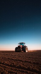 Obraz premium Tractor Plowing Field Under Starry Night Sky in Rural Landscape