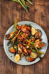 Baked chicken wings with vegetables.