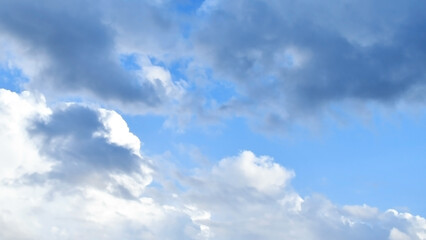 Blue sky white and dark fluffy cloud after rain and storm. Cumulus clouds background. Cloudscape sky. The concepts of freedom of life, never give up and positive though energy.
