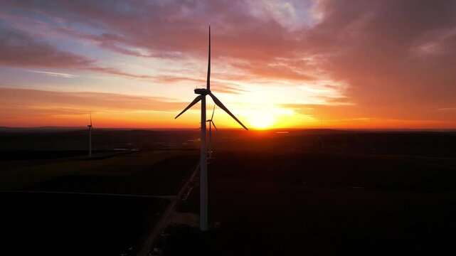 Windmill turbines generating green energy electric.Green energy helps reduce carbon emissions and makes earth cleaner and more ecological.	