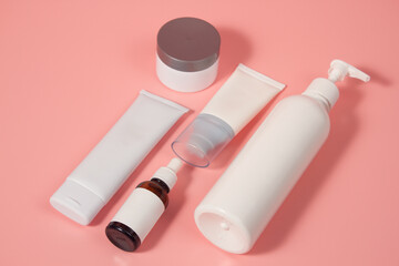 Empty tubes of cream on a pink background. Complex of creams for skin care.