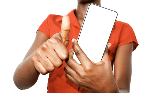 Young Black African lady woman wearing orange shirt holding pointing showing mobile phone with blank screen and making thumbs up to camera over transparent background. mockup tempates

