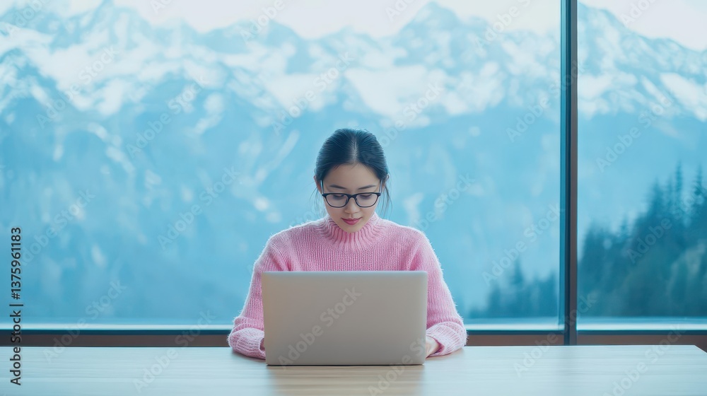 Poster Woman sitting at a table with a laptop in front of her, engaged in work and focused on a task in a cozy environment