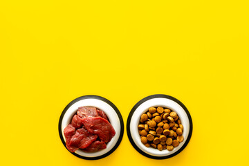 Pet food in bowls - meat and dry food, top view