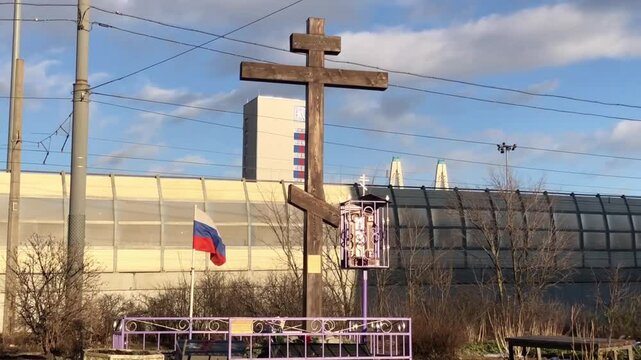 wooden cross and tricolor flag on grave