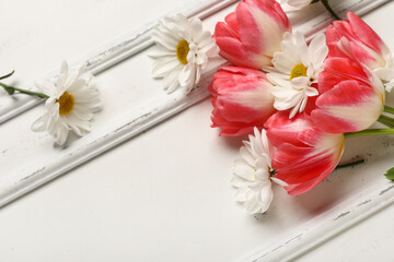 Beautiful tulips and chamomile flowers on white background. Mother's Day celebration