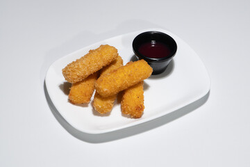 Golden Fried Mozzarella Sticks Served on a White Plate with Sweet Dipping Sauce
