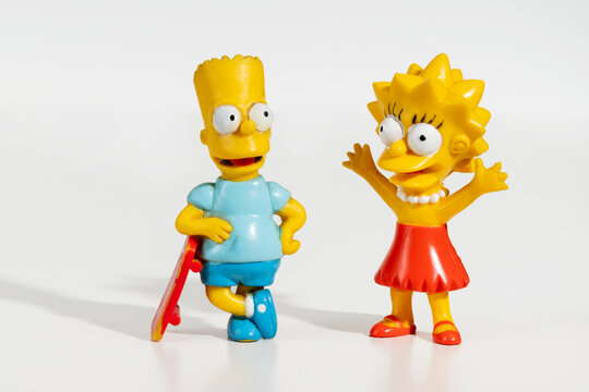 Bart and Lisa Simpson figurines standing on white background