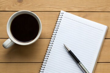  cup of black coffee, a lined notepad, and a pen placed on a wooden surface. The setup suggests a workspace or a moment of reflection, perfect for journaling, planning, or brainstorming ideas.