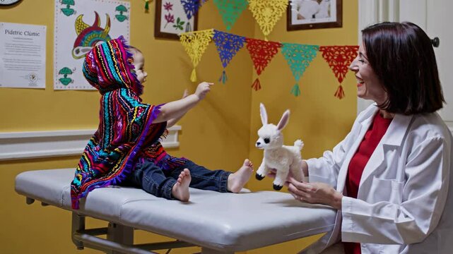 Cheerful pediatrician uses a llama toy to entertain a baby sitting on an examination table, creating a playful and comfortable environment in the pediatric clinic
