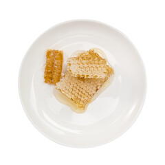 Honeycomb on white plate. Isolated on a white background. Top view.