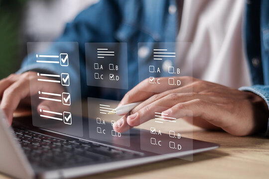 Online exam concept, Online education, assessment, questionnaire, evaluation. Man use laptop choose answers for exam tests.