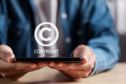 Intellectual copyright concept. Copyright or patent. Man show copyright icons for author rights and patent intellectual property.