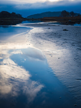Reflection of sky on water in lake at dawn