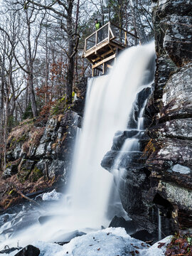 Low angle view on tower and waterfall on mountain