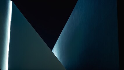 Angular Interplay: An Abstract Study of Light, Shadow, and Form Revealing Deep Blue and Stark White Contrasts.