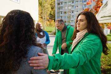 Female volunteer with hand on shoulder of woman at park