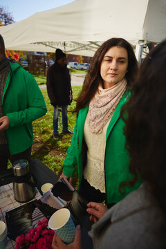 Female charity owner talking with woman about mental health program to woman at park