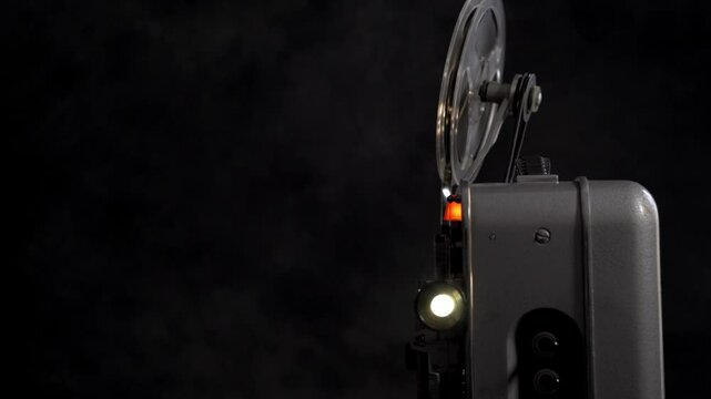 Vintage movie projector in good condition with blank film for display.