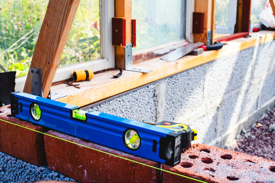 Level tool kept on bricks at construction site