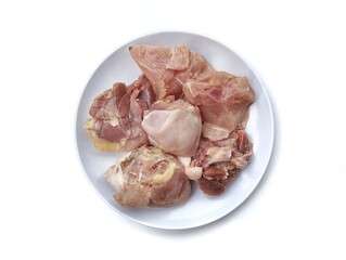 Fresh raw chicken meat slices on plate isolated on white background, Top view 