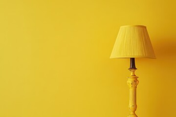 A yellow lamp standing against a plain bright yellow wall