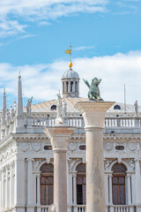 Fototapeta premium Cover page with San Marco square roof top towers, sculptures and the symbol of Venice a winged lion at Doge Palace, Venice, Italy, summer time, closeup, details
