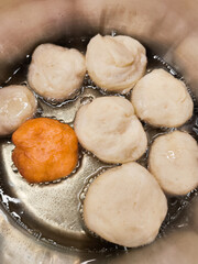 Frying baursaki, traditional doughnuts from central asia, in prague