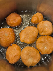 Traditional czech baursaki doughnuts frying in hot oil in prague