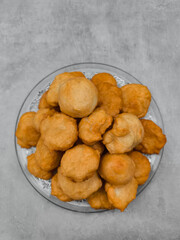 Baursaki, traditional fried dough pastry, on glass plate in prague copy space