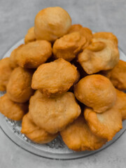 Freshly made baursaki piled high on glass plate in prague